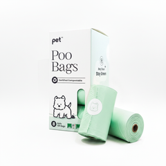 Roll of green dog poop bags with packaging on a white background